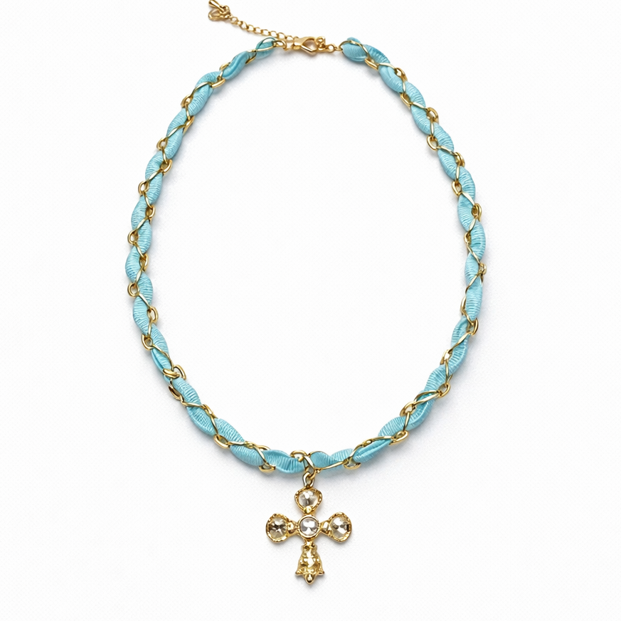 Turquoise braided necklace with gold accents and a cross pendant on a white background